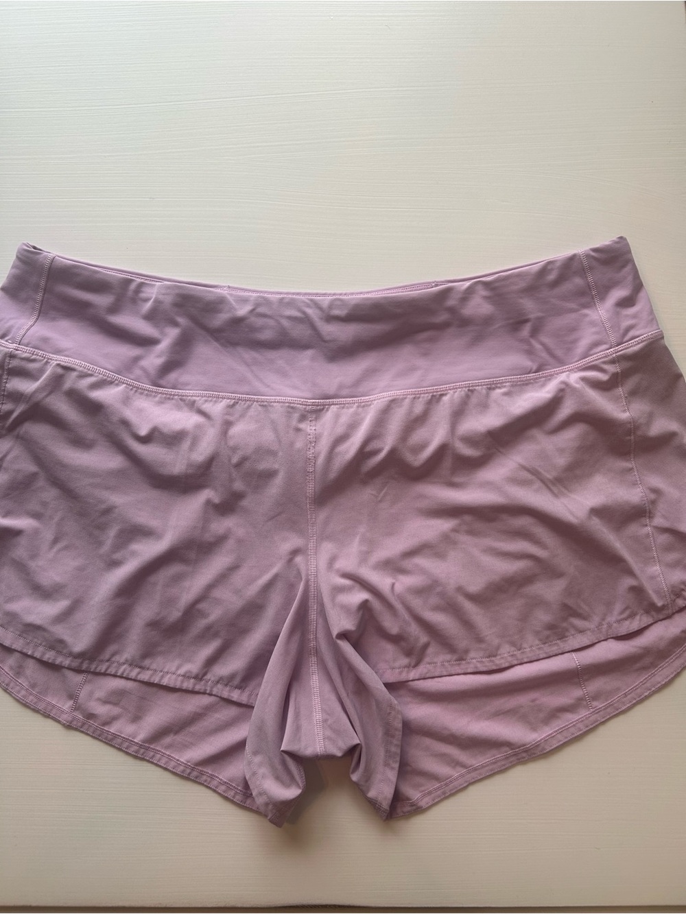 2 pairs of Lululemon athletica one Lilac and onewhite Performance Running Shorts